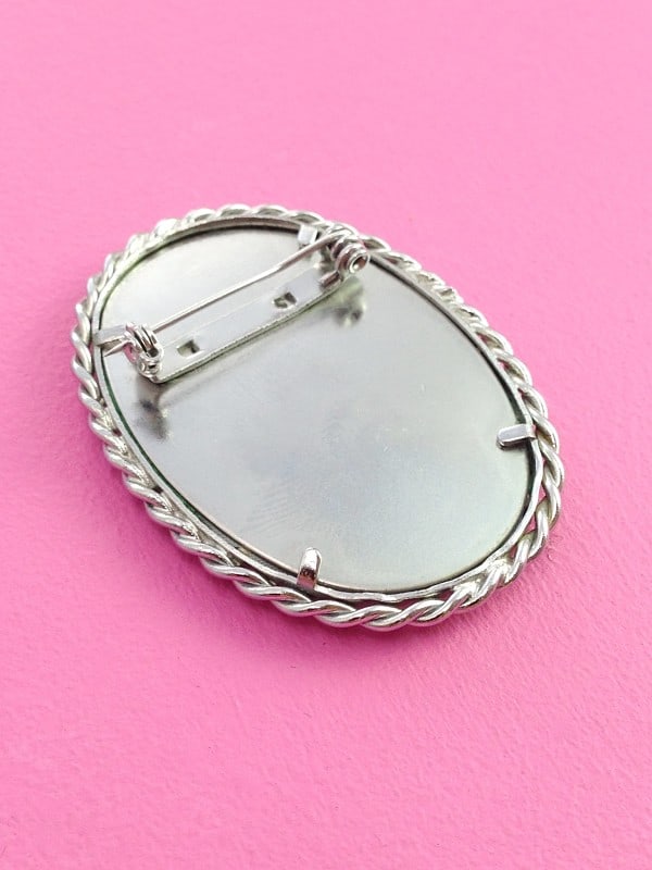 Handmade oval scene stitched brooch back