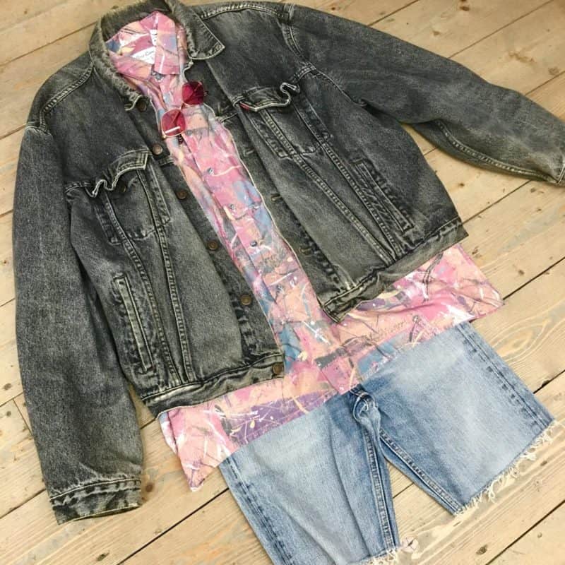 Picture shows Ct Cyr denim jacket teamed with cut of jeans, patterned shirt and pink sunnies