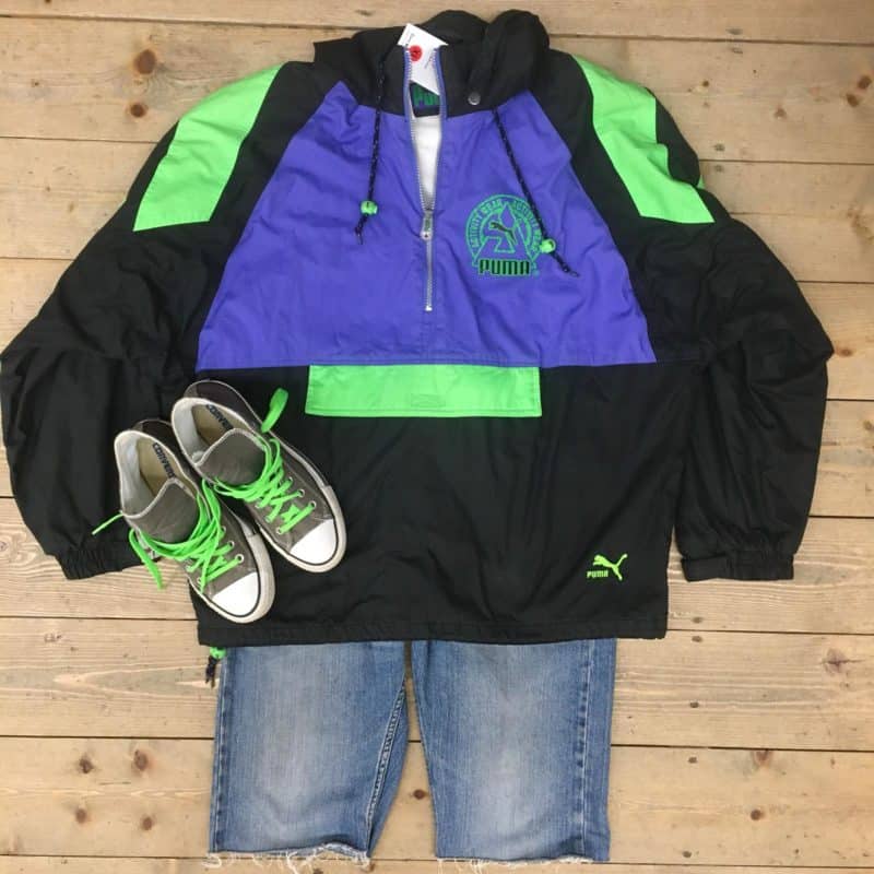 Image shows retro puma pull-over sports top with cit off jeans and grey Converse. 
