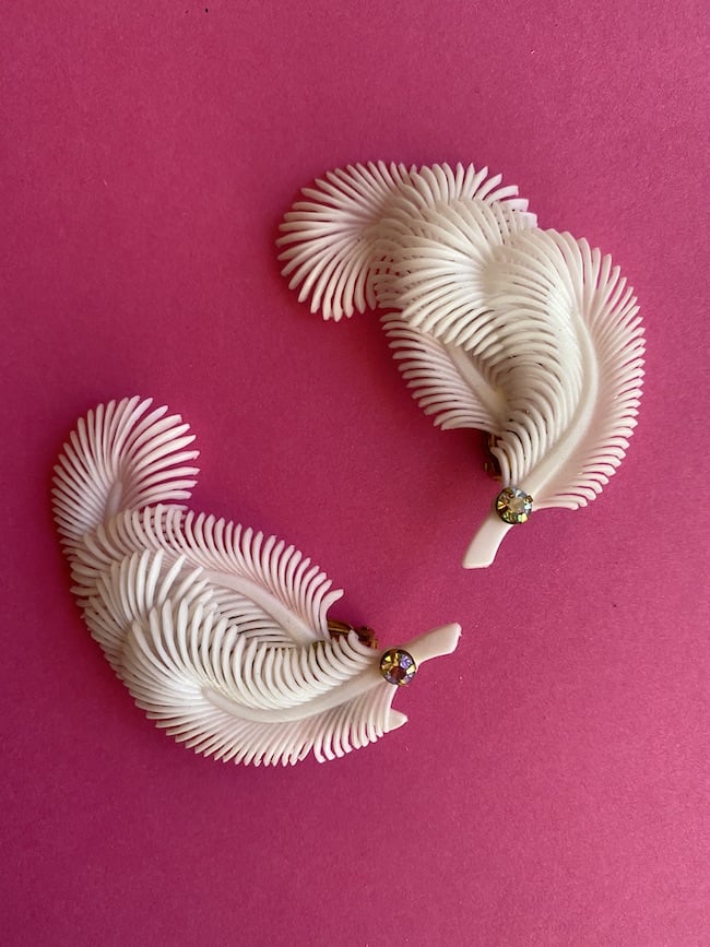 image of a pair of clip on Deadstock Vintage Feather Earrings in White with rhinestones