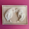 image showing a pair of deadstock vintage feather earrings on original card, in white
