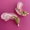 Image shows the back of a pair of Vintage Feather Earrings in Pink which have four layers of feathers (plastic) and a rhinestone detail. The back has a clip on fastening and they are very pretty