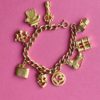 an image showing a golden Vintage ALUCRAFT Charm Bracelet