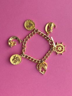 image shows a Vintage Charm Bracelet with charms including a Ship Wheel