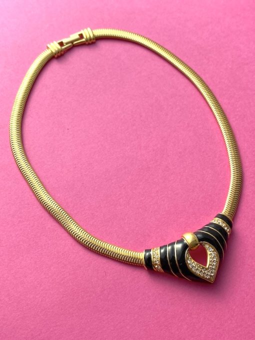 an image of a 1980s vintage SAL swarovski necklace on a pink background