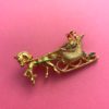 image of a vintage brooch depicting a sleigh and horse