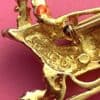 image of a vintage brooch depicting a sleigh and horse, showing the back where it is signed Gerrys