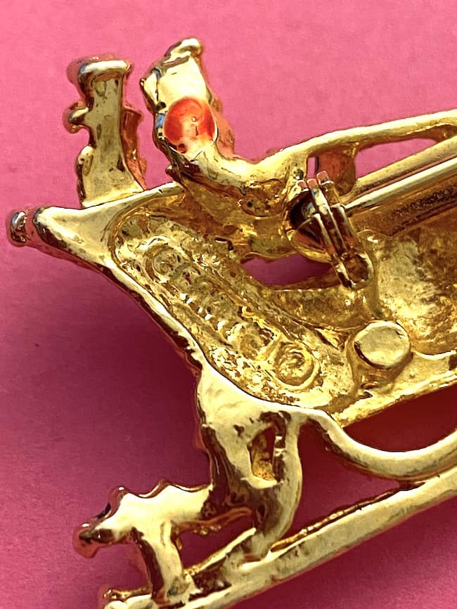 image of a vintage brooch depicting a sleigh and horse, showing the back where it is signed Gerrys